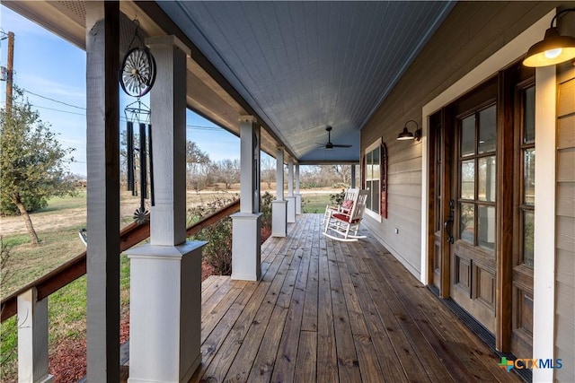 deck with a porch and ceiling fan