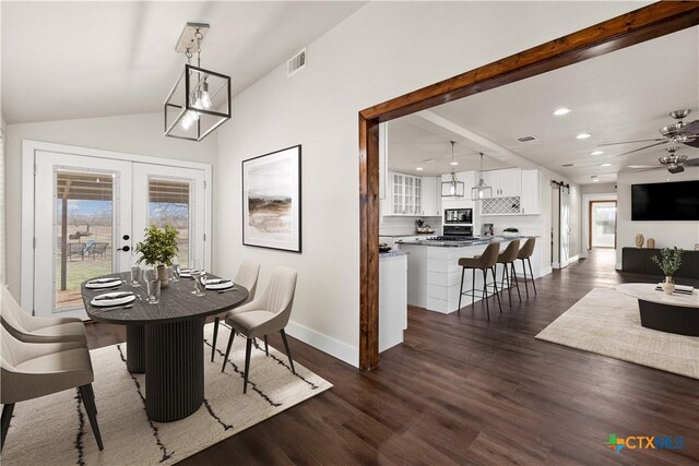 dining room with baseboards, lofted ceiling, recessed lighting, french doors, and dark wood-style floors