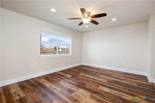 spare room featuring recessed lighting, baseboards, dark wood-style floors, and a ceiling fan