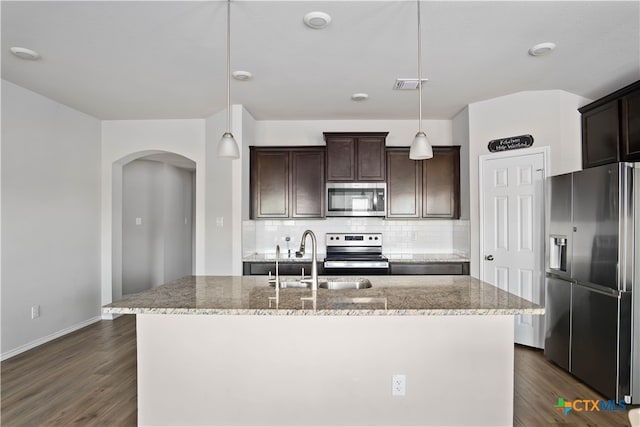 kitchen with dark wood-type flooring, pendant lighting, appliances with stainless steel finishes, and sink