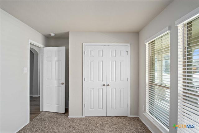 unfurnished bedroom featuring a closet and carpet flooring