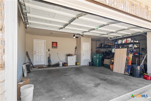 garage with a garage door opener and washer / dryer