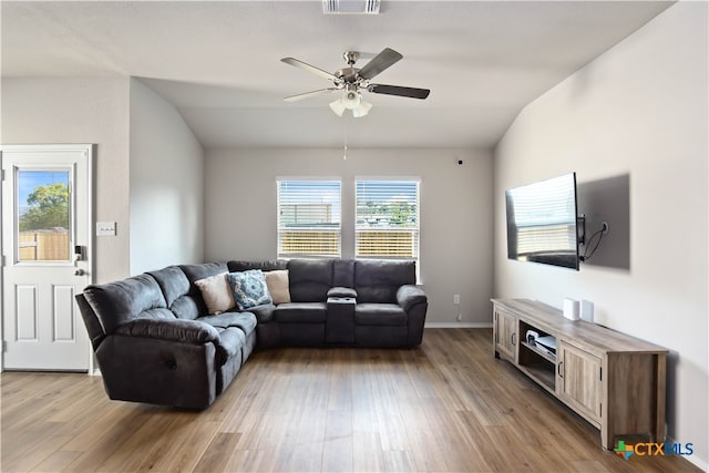 living room featuring light wood-type flooring, vaulted ceiling, and ceiling fan