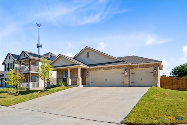 view of front facade with a garage, a front lawn, and a balcony