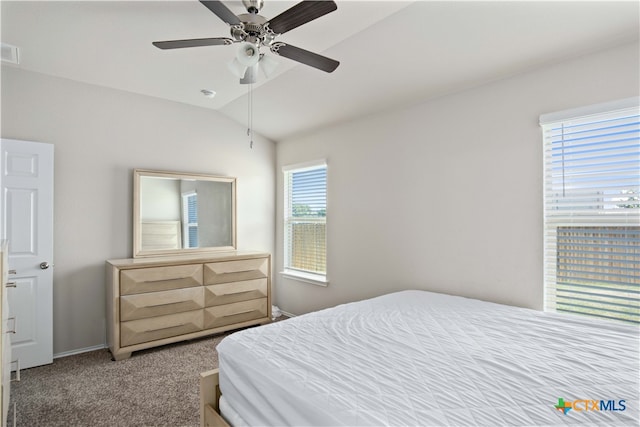 bedroom with carpet flooring, lofted ceiling, multiple windows, and ceiling fan