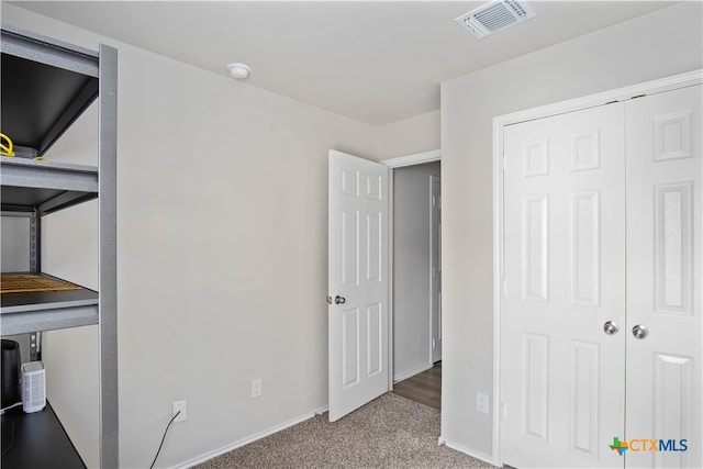 unfurnished bedroom with carpet and a closet