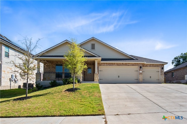 view of front of property featuring a garage and a front lawn