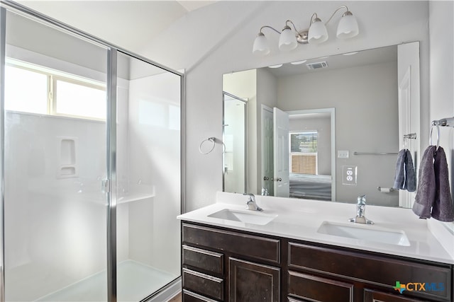 bathroom with vanity and a shower with door