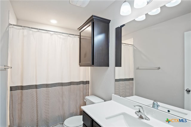 bathroom with vanity and toilet