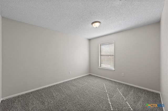 carpeted spare room featuring a textured ceiling