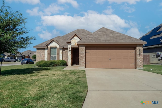 view of front of property with a front lawn and a garage