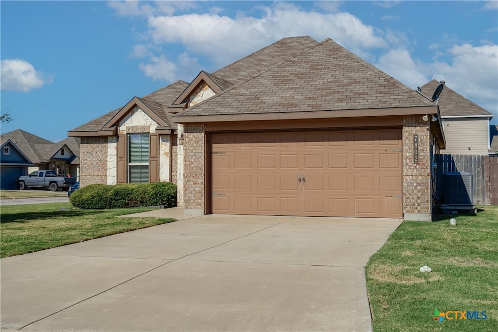 view of front of property featuring a garage and a front yard