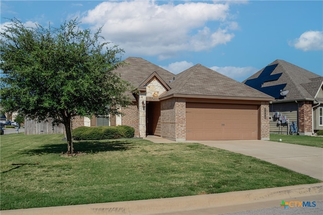 view of front of home featuring a garage and a front yard