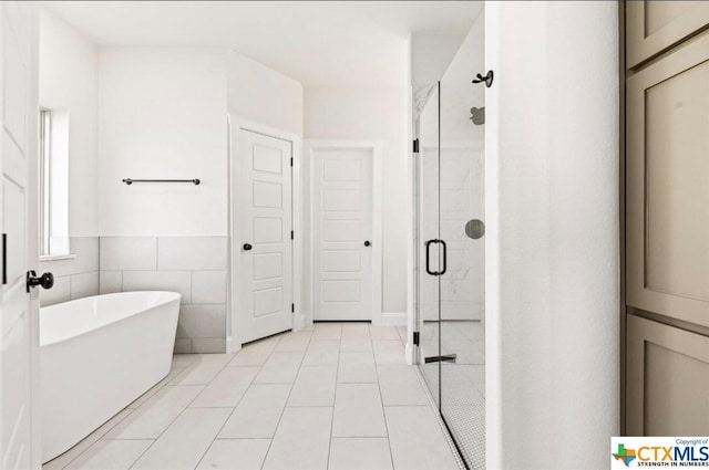122 Overlook Trl, Copperas Cove, TX 76522 - full bath featuring a stall shower, a freestanding bath, tile patterned floors, and tile walls