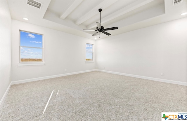 carpeted spare room with beamed ceiling, ceiling fan, and a healthy amount of sunlight