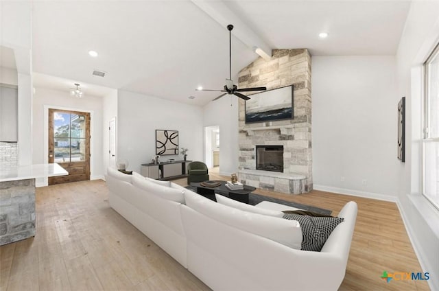 122 Overlook Trl, Copperas Cove, TX 76522 - living area with a stone fireplace, light wood finished floors, a ceiling fan, and baseboards