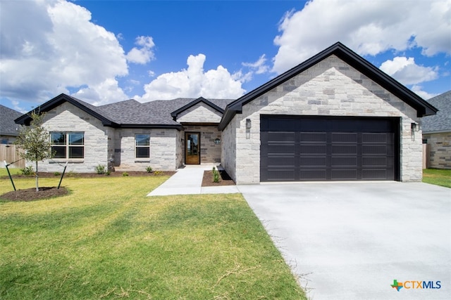 view of front of property featuring a garage and a front lawn