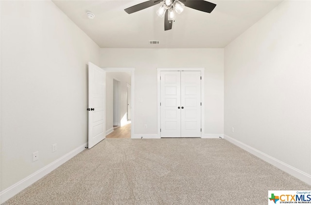 unfurnished bedroom with light carpet, a closet, and ceiling fan