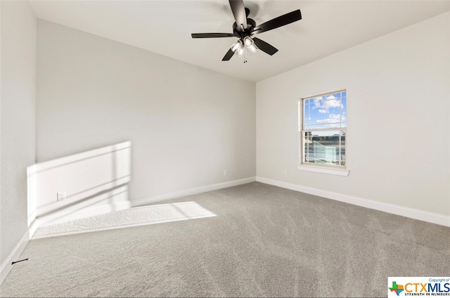 carpeted spare room with ceiling fan