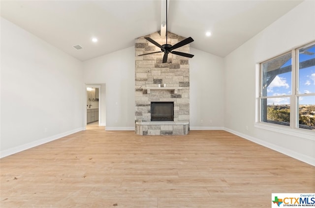 unfurnished living room featuring vaulted ceiling with beams, ceiling fan, a stone fireplace, and light hardwood / wood-style flooring