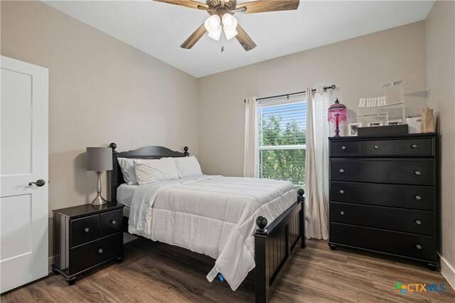 bedroom with hardwood / wood-style floors and ceiling fan