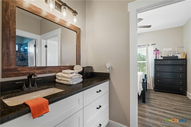 bathroom with vanity, hardwood / wood-style flooring, and ceiling fan