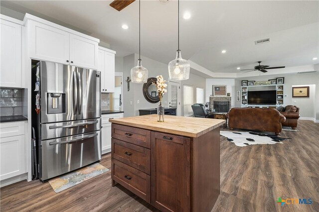 kitchen featuring white cabinets, dark hardwood / wood-style flooring, ceiling fan, and stainless steel fridge with ice dispenser