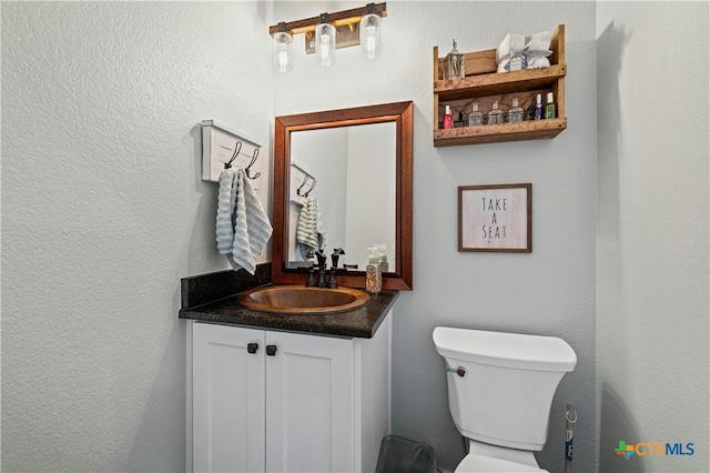 bathroom featuring toilet and vanity