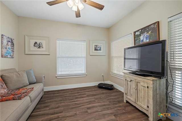 living room featuring ceiling fan, dark hardwood / wood-style floors, and plenty of natural light