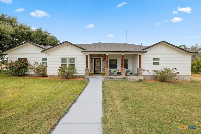 ranch-style house with a front yard and covered porch