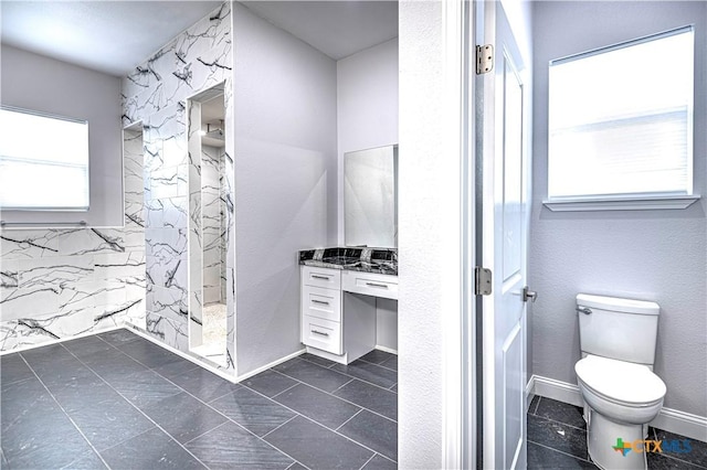 bathroom with vanity, toilet, and walk in shower