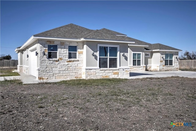 rear view of property with a garage