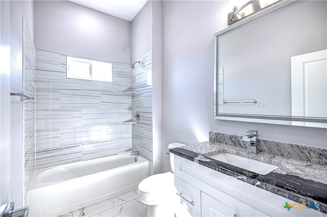 full bathroom with vanity, toilet, and tiled shower / bath