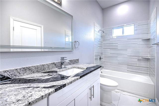 full bathroom featuring vanity, tiled shower / bath combo, and toilet