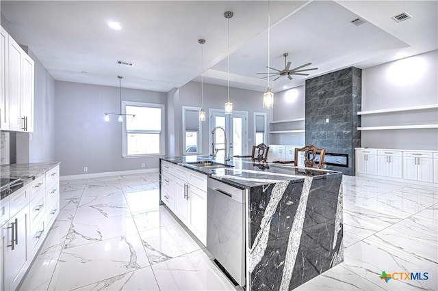 kitchen with white cabinets, sink, stainless steel appliances, and dark stone counters