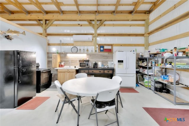 407 W Oakland Ave, Seadrift, TX 77983 - kitchen featuring black appliances, finished concrete flooring, and a sink