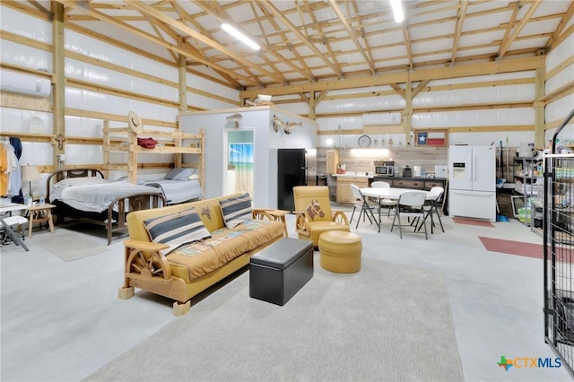 407 W Oakland Ave, Seadrift, TX 77983 - garage with white fridge with ice dispenser and freestanding refrigerator