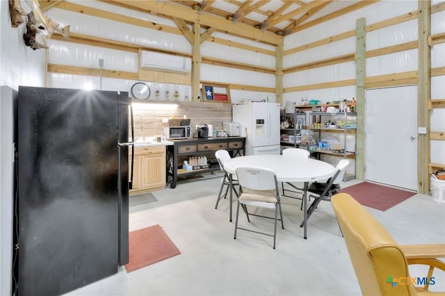 407 W Oakland Ave, Seadrift, TX 77983 - dining area featuring an AC wall unit and concrete floors