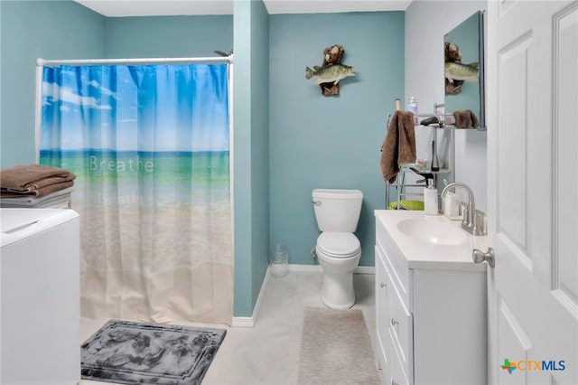 bathroom featuring toilet, vanity, and separate washer and dryer