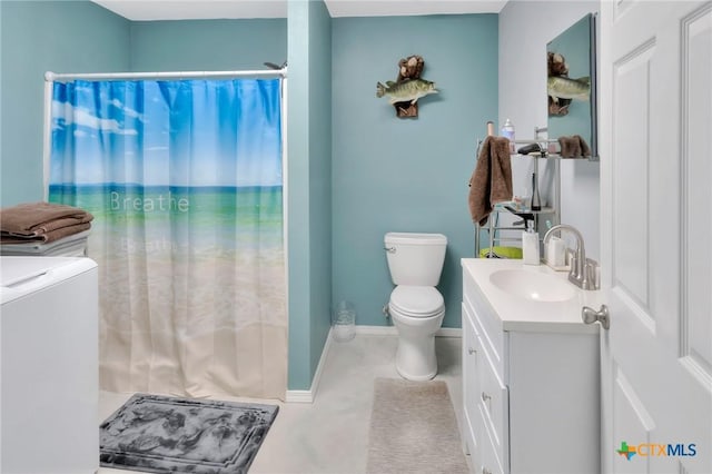 407 W Oakland Ave, Seadrift, TX 77983 - bathroom featuring washing machine and dryer, vanity, toilet, and curtained shower