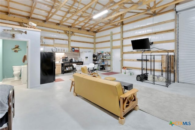 407 W Oakland Ave, Seadrift, TX 77983 - living room with high vaulted ceiling, concrete floors, and a garage