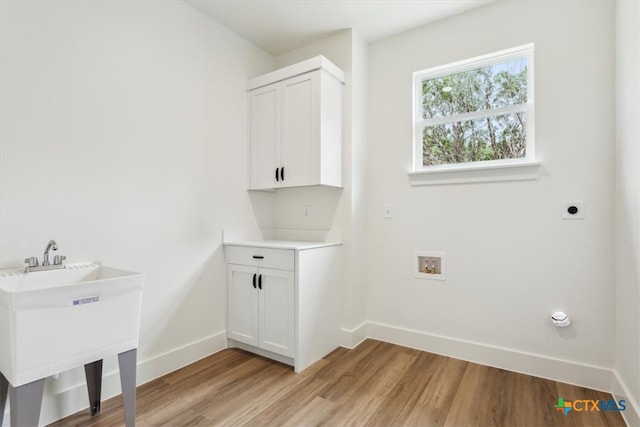 laundry room featuring washer hookup, light hardwood / wood-style floors, and hookup for an electric dryer