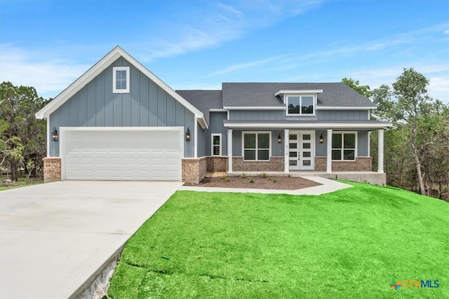 craftsman-style house with covered porch, a garage, and a front yard