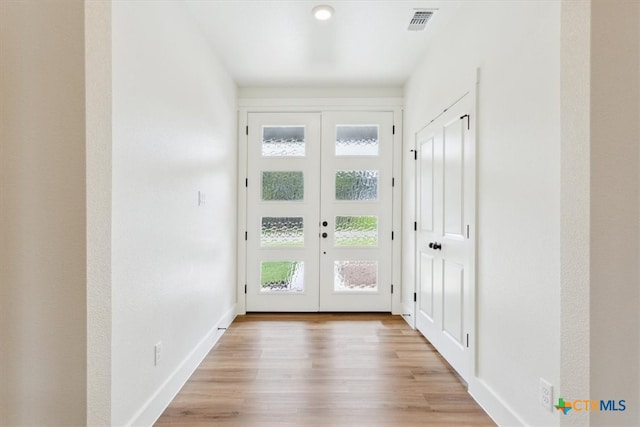 entryway featuring french doors and light hardwood / wood-style floors