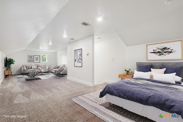 carpeted bedroom with lofted ceiling