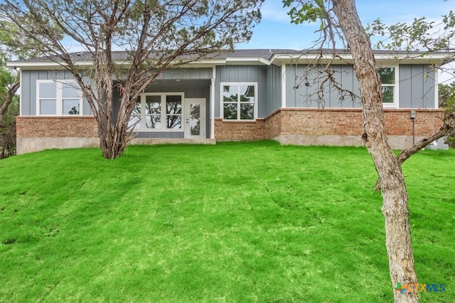 rear view of house with a yard