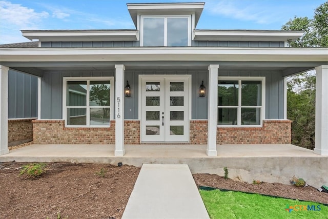 view of exterior entry with covered porch