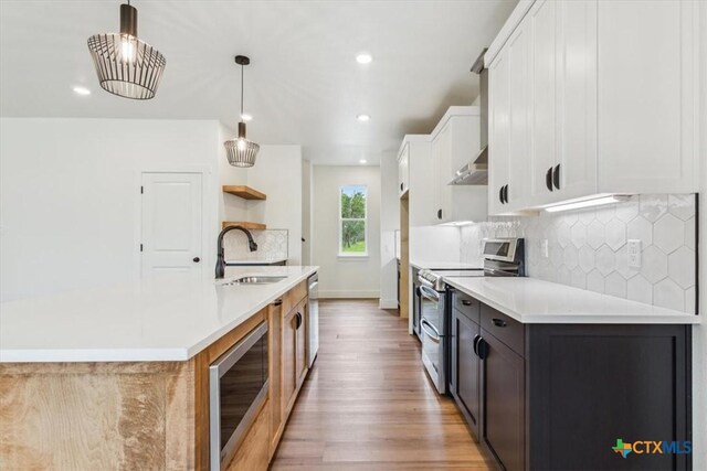 5116 Goliad Dr, Temple, TX 76502 - kitchen featuring a sink, stainless steel appliances, light wood-style floors, light countertops, and white cabinetry