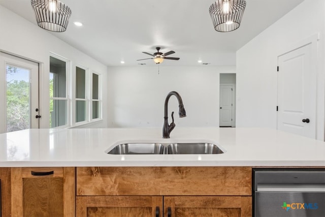 kitchen featuring a kitchen island with sink, stainless steel dishwasher, sink, and ceiling fan