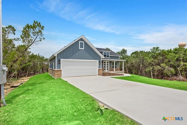 view of front of home with a garage and a front lawn